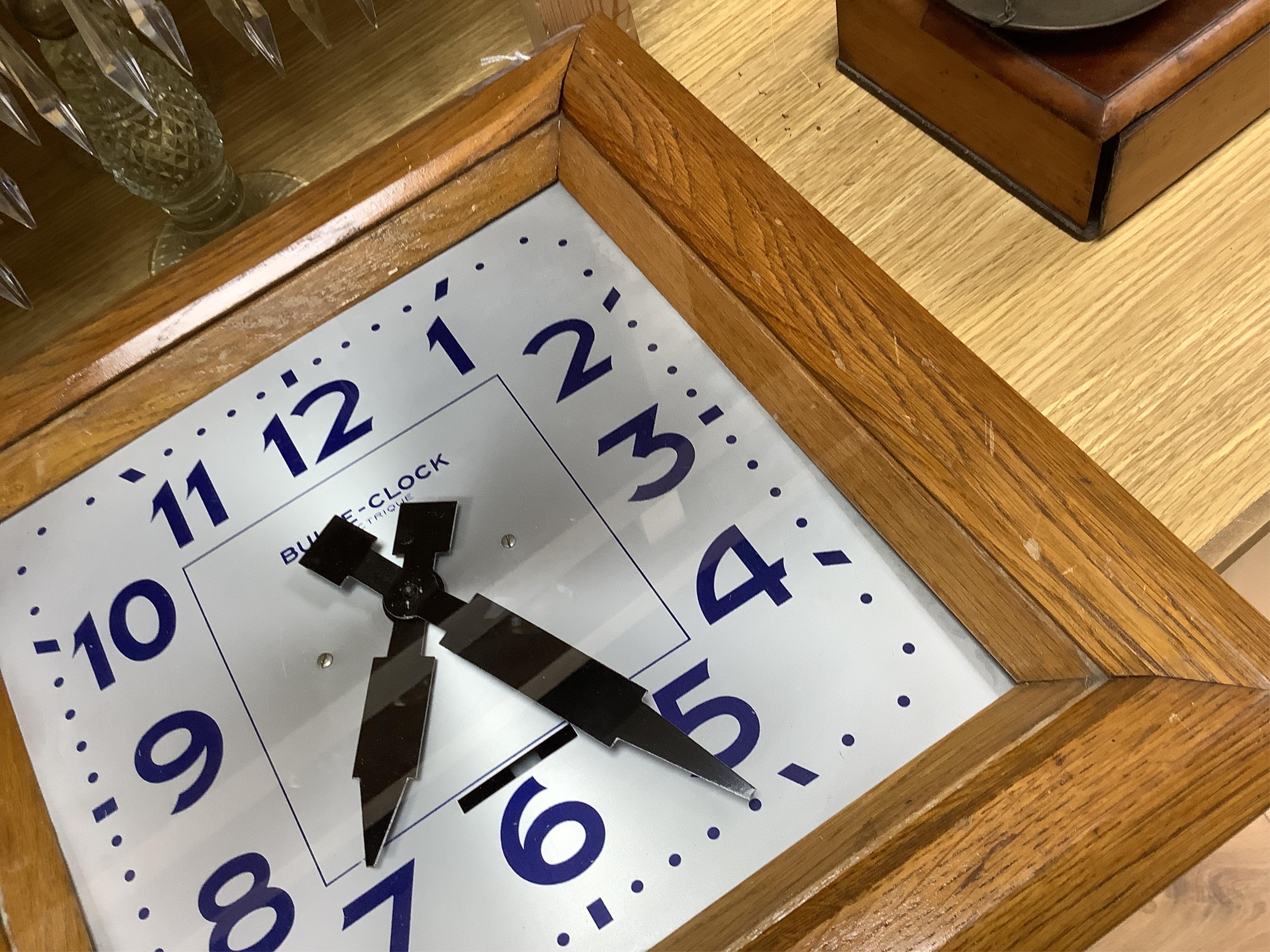 An early 20th century French Art Deco Bulle Electrique oak wall clock, 39cm squared. Condition - scratch to oak on front cover, not checked if working